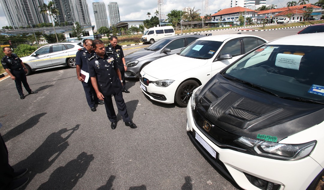 Johor police chief Datuk Ayob Khan Mydin Pitchay inspecting the seized vehicles from a recent raid at the Johor police contingent headquarters in Johor Baru June 29, 2020. u00e2u20acu201d Picture by Ben Tan