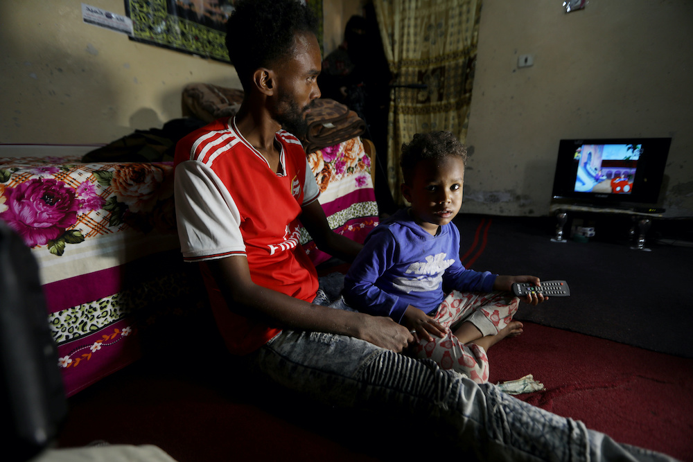 Somali refugee Bader Abdullah Hassan sits with his son, Muhammad, at their house in Sanaa, Yemen June 18, 2020. u00e2u20acu2022 Reueters pic