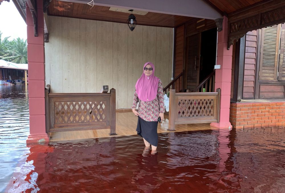 A woman wades through flood waters in Kampung Parit Pulai, Batu Pahat June 21, 2020. u00e2u20acu201d Bernama pic