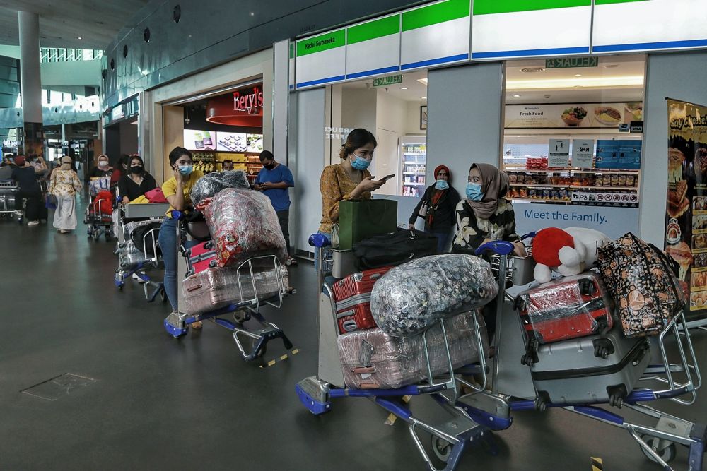 People wearing face masks are pictured at KLIA2, Sepang on the first day of the recovery movement control order June 10, 2020. u00e2u20acu201d Picture by Ahmad Zamzahuri