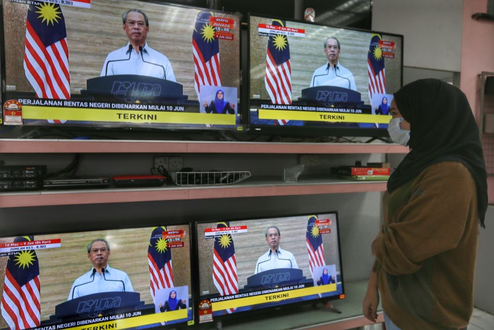 A woman watches a live broadcast of Prime Minister Tan Sri Muhyiddin Yassin on the recovery movement control order in Kuala Lumpur June 7, 2020. u00e2u20acu2022 Picture by Ahmad Zamzahuri