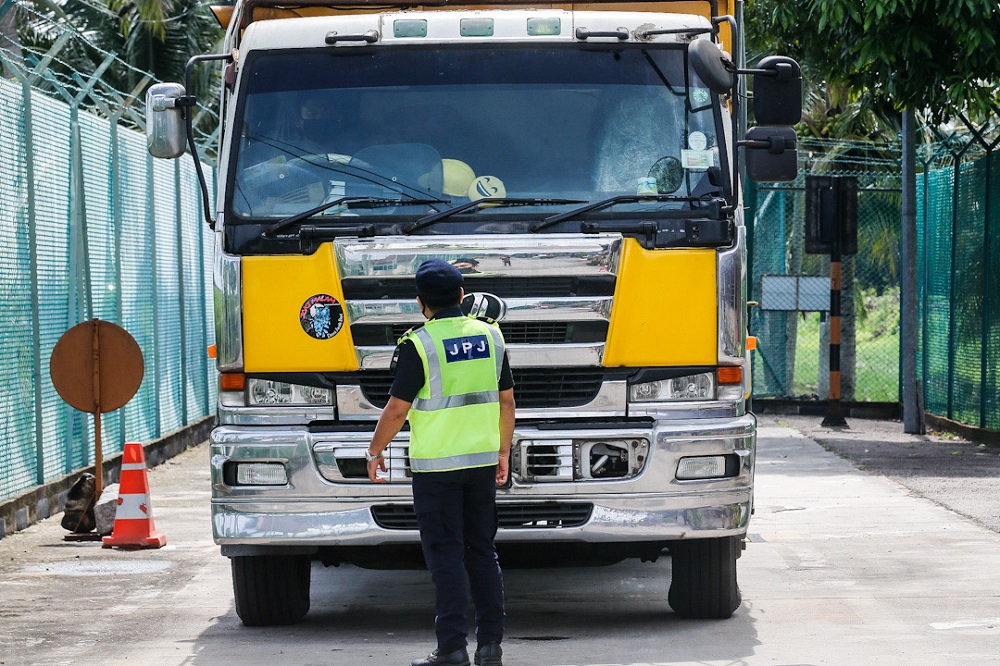 A Road Transport Department officer inspects the weight of a lorry at the Road Transport Department Enforcement Station in Penaga July 23, 2020. Picture by Sayuti Zainudin