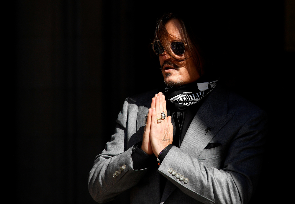 Actor Johnny Depp gestures as he arrives at the High Court in London, Britain July 28, 2020. u00e2u20acu201d Reuters pic