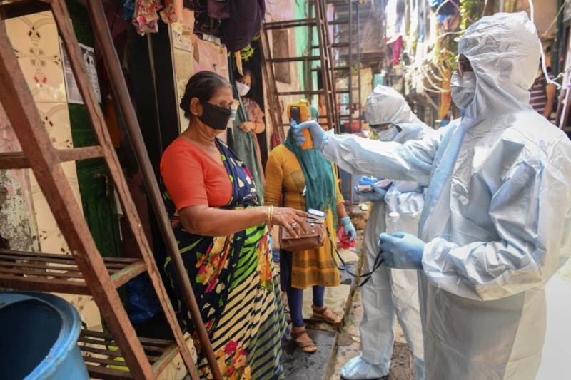 Medical staff wearing personal protective equipment (PPE) conduct a door-to-door medical screening inside the Dharavi slums. u00e2u20acu2022 AFP pic