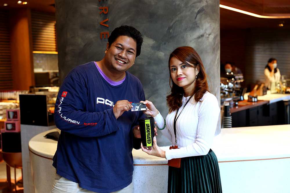 Marketing and loyalty senior manager Thila Chandran (right) presenting Luqman with the Starbucks and Undefeated merchandise and a Starbucks Rewards card. — Picture courtesy of Starbucks Malaysia