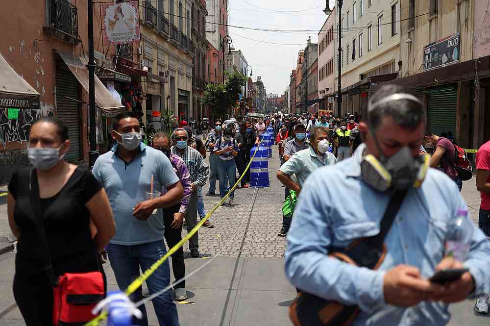 People wait in line along the street before entering the area where stores are open, during the gradual reopening of commercial activities in Mexico City, Mexico July 6, 2020. u00e2u20acu201d Reuters pic