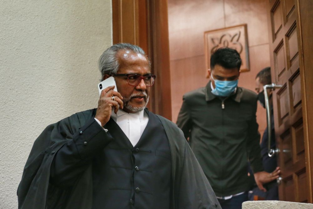 Lawyer Tan Sri Muhammad Shafee Abdullah speaks on his phone at the Kuala Lumpur Court Complex July 28, 2020. u00e2u20acu2022 Picture by Ahmad Zamzahuri