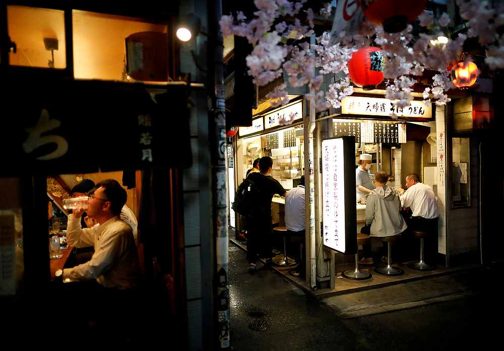 People enjoy drinks and dinner at the partially reopened Japanese drinking bars alley, after the Japanese government lifted the state of emergency at Shinjuku district in Tokyo May 26, 2020. u00e2u20acu201d Reuters pic