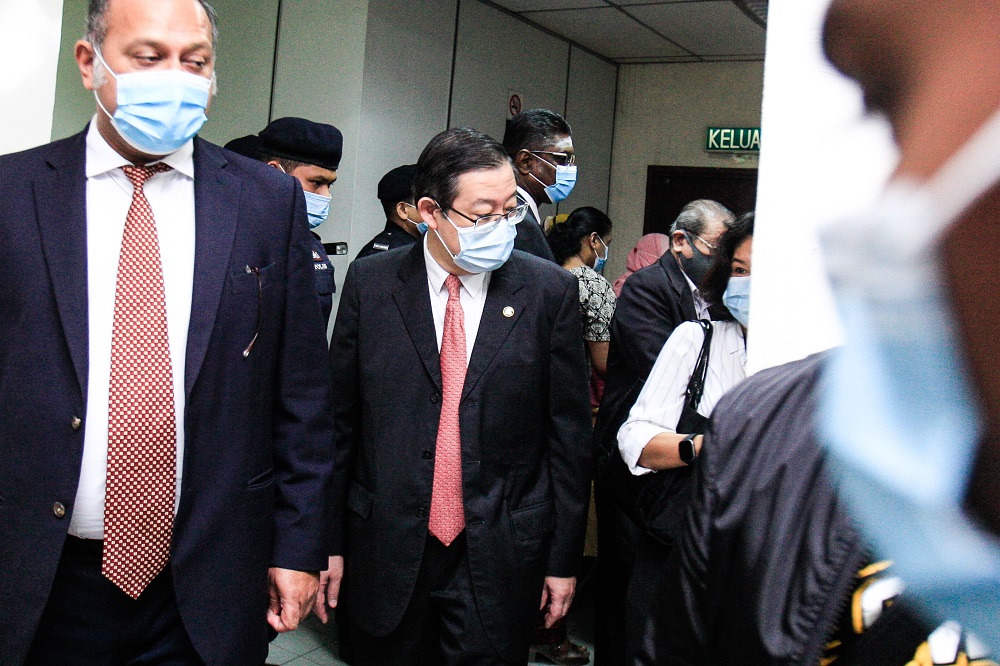 Lim Guan Eng (centre) and his lawyer Gobind Singh Deo (left) and Ramkarpal Singh (right) exiting the Butterworth Court Complex August 10, 2020. — Picture by Sayuti Zainudin