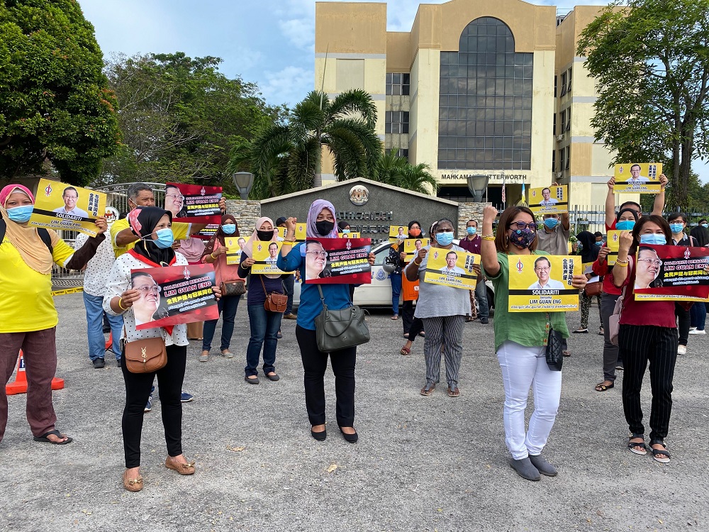 Lim Guan Eng’s supporter are seen with placards outside the Butterworth courthouse August 11, 2020. — Picture by Steven KE Ooi