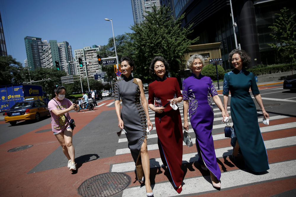 Members of an internet celebrity model group Glamma Beijing wearing traditional Chinese dresses walk across a street during a video shoot in Beijingu00e2u20acu2122s Central Business District (CBD) area, China August 13, 2020. u00e2u20acu201d Reuters pic