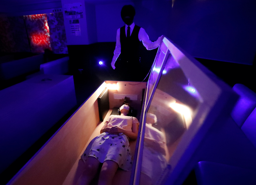 A participant lies inside a mock of coffin with plastic shields to maintain social distancing amid the spread of the coronavirus disease, during a coffin horror show, performed by Kowagarasetai (Scare Squad), in Tokyo, Japan August 22, 2020. u00e2u20acu201d Reuters p
