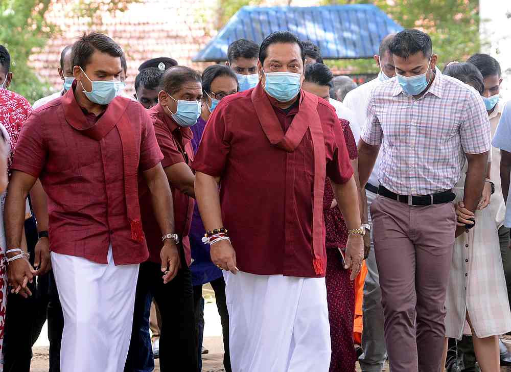 Leader of Sri Lanka People's Front party and Prime Minister Mahinda Rajapaksa (centre) wearing a protective mask arrives to cast his vote in Medamulana, Sri Lanka August 5, 2020. u00e2u20acu201d Reuters pic