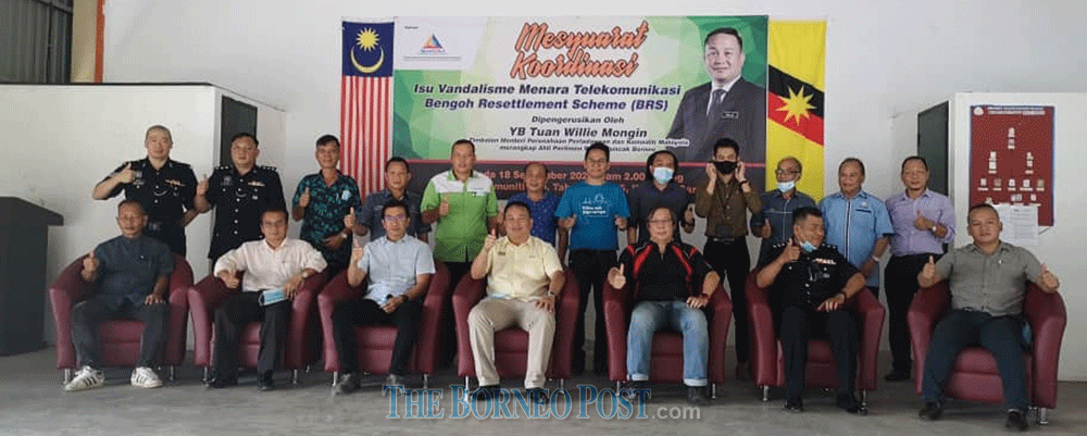 Willie (seated, centre) flanked by Adiman (third left) and Amrul (third right) and others in a photo call after the meeting. u00e2u20acu201d Borneo Post Online pic