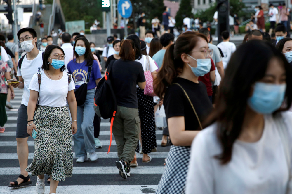 People wearing face masks following the coronavirus disease outbreak walk across a street at a shopping area in Beijing, China August 25, 2020. u00e2u20acu201d Reuters pic 