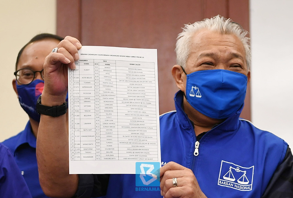 Datuk Seri Bung Moktar Radin holds up the list of Umno candidates in Kota Kinabalu September 10, 2020. u00e2u20acu201d Bernama pic