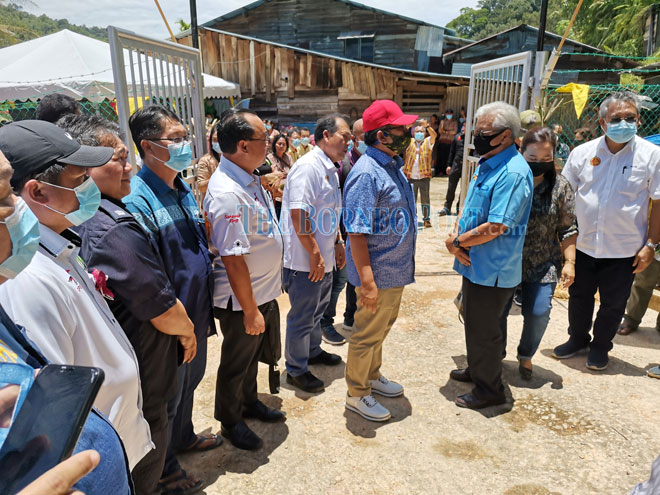 Tan Sri Datuk Amar James Masing (right) leads a party to welcome Minister of Rural Development Datuk Abdul Latiff Ahmad on arrival at Rumah Layang. u00e2u20acu2022 Borneo Post pic