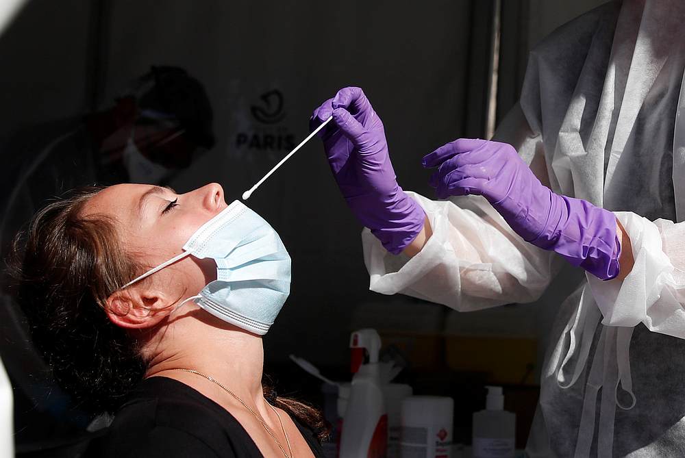 A health worker prepares to administer a nasal swab to a patient at a testing site for Covid-19 in Paris, France, September 14, 2020. — Reuters pic