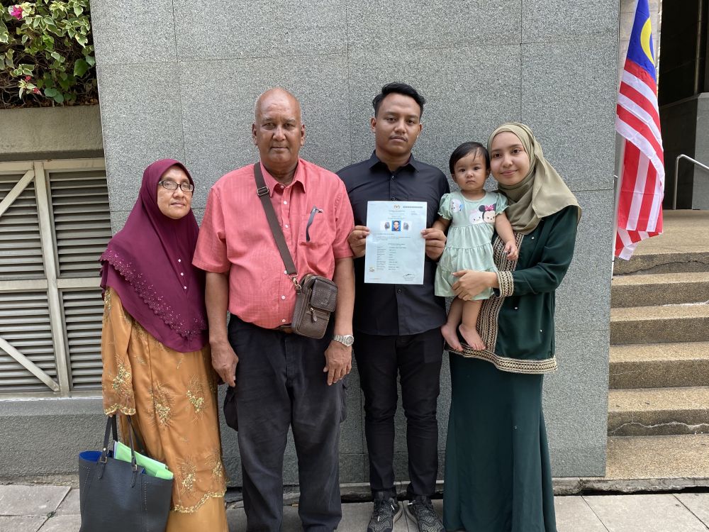 Muhammad Aiman Hafizi Ahmad, 20 (third from left), together with his family after collecting his certificate of citizenship at the National Registration Department in Putrajaya. September 1, 2020. u00e2u20acu2022 Picture courtesy of Lee Yee Woei