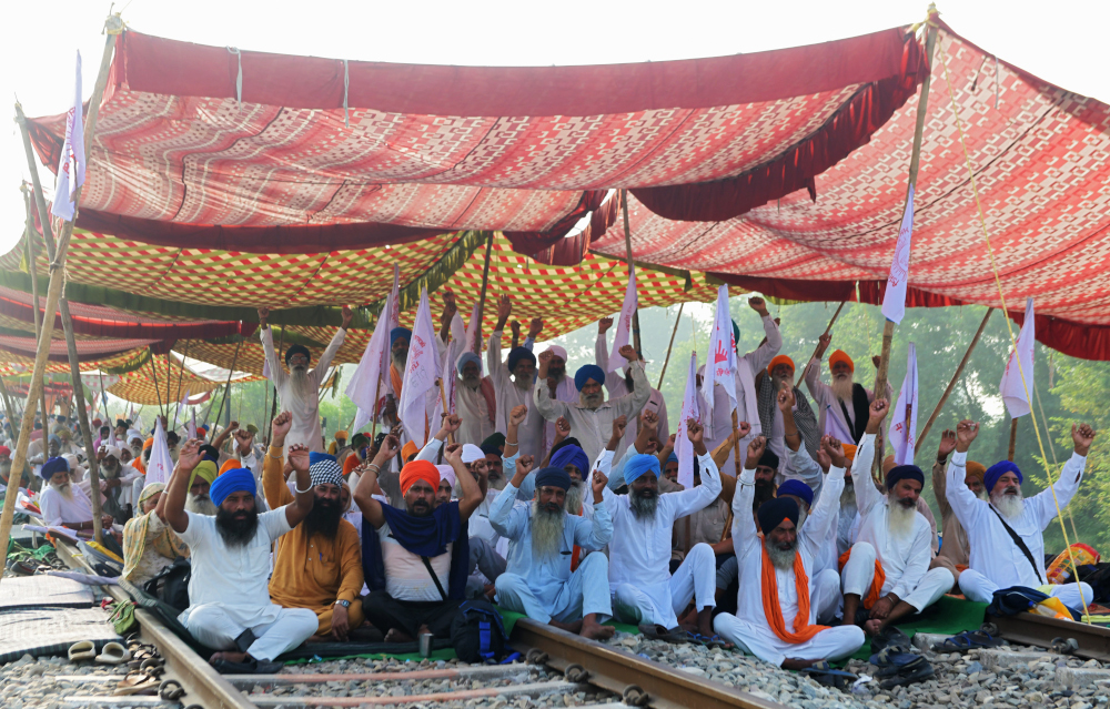 Farmers shout slogans and block train tracks during a nationwide farmersu00e2u20acu2122 strike following the recent passing of agriculture bills in the Lok Sabha (lower house), at Devi Dasspura village some 25km from Amritsar on September 25, 2020. u00e2u20acu201d AFP pic