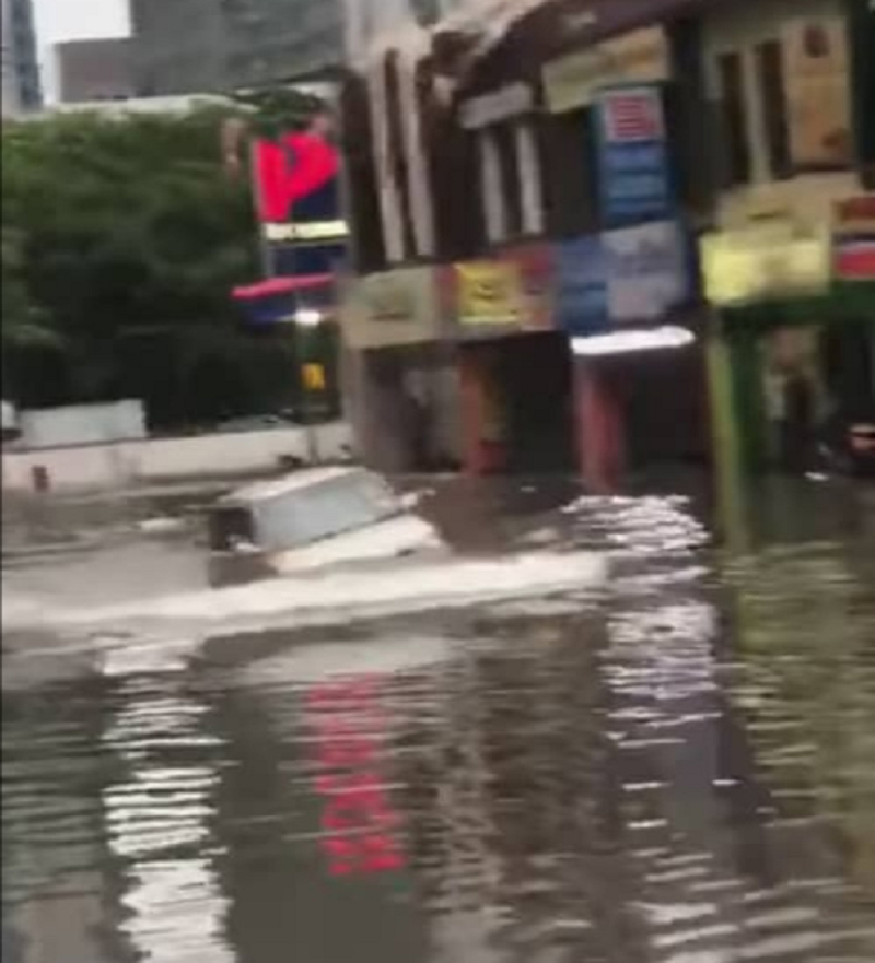 A screenshot of a video grab that showed a Perodua Kelisa wading through a flooded Jalan Dang Wangi in Kuala Lumpur yesterday. u00e2u20acu2022 Picture via Facebook/ Info Roadblock JPJ/ POLIS