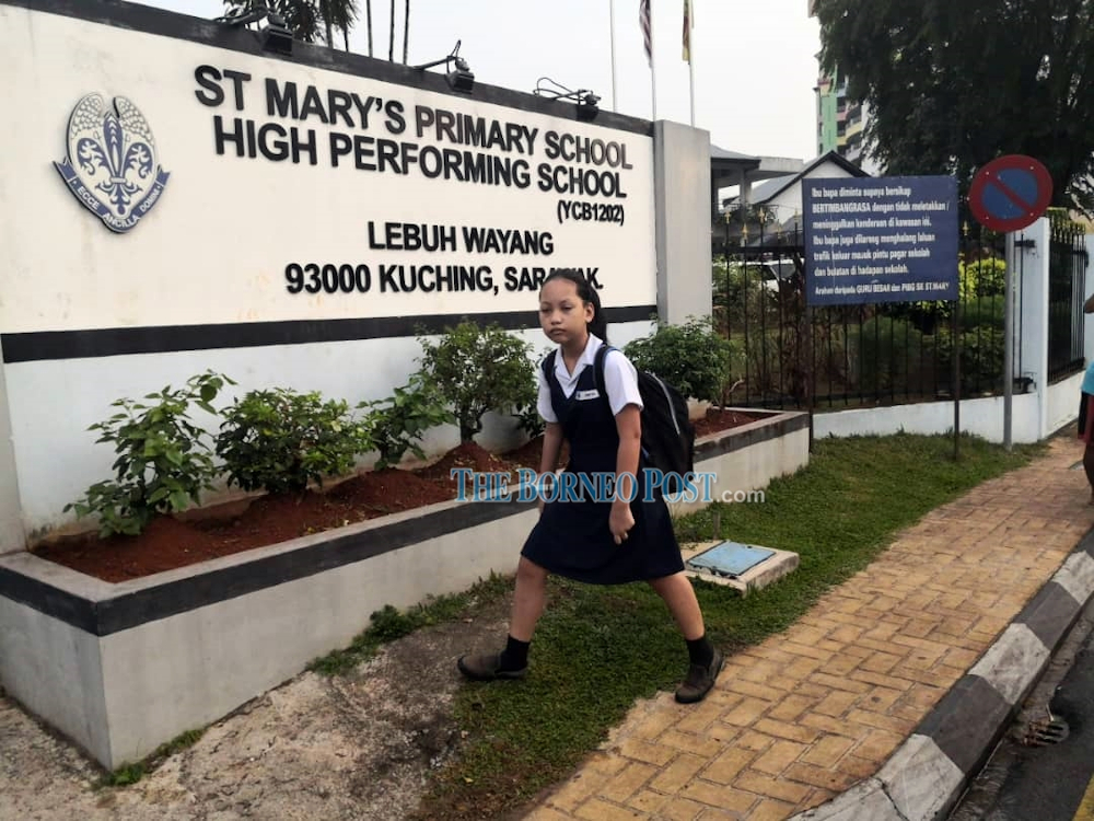 File photo of a St Maryu00e2u20acu2122s primary school pupil arriving at the school. u00e2u20acu201d Borneo Post pic 