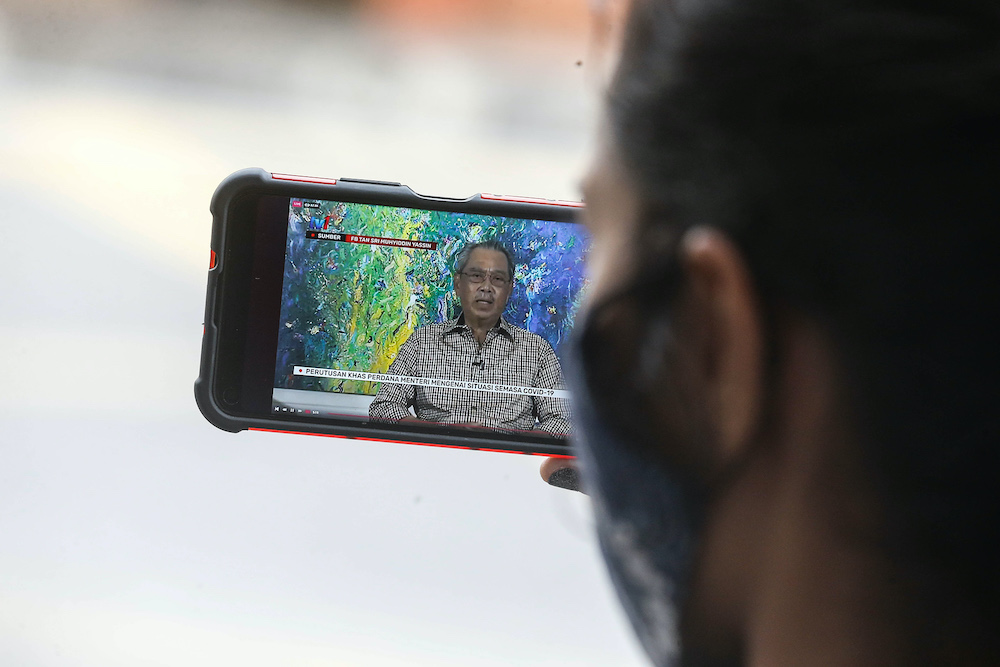 A woman watches the special announcement by Prime Minister Tan Sri Muhyiddin Yassin on her smartphone, October 6, 2020. — Picture by Sayuti Zainudin A woman watches the special announcement by Prime Minister Tan Sri Muhyiddin Yassin on her smartphone, October 6, 2020. — Picture by Sayuti Zainudin