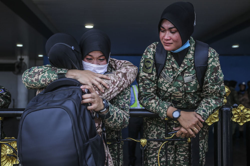 Members of the Malaysia MALBATT 850-8 battalion who will join the United Nations Interim Force (Unifil) in Lebanon hug their family at the Subang air base, Shah Alam on October 1, 2020. — Picture by Hari Anggara