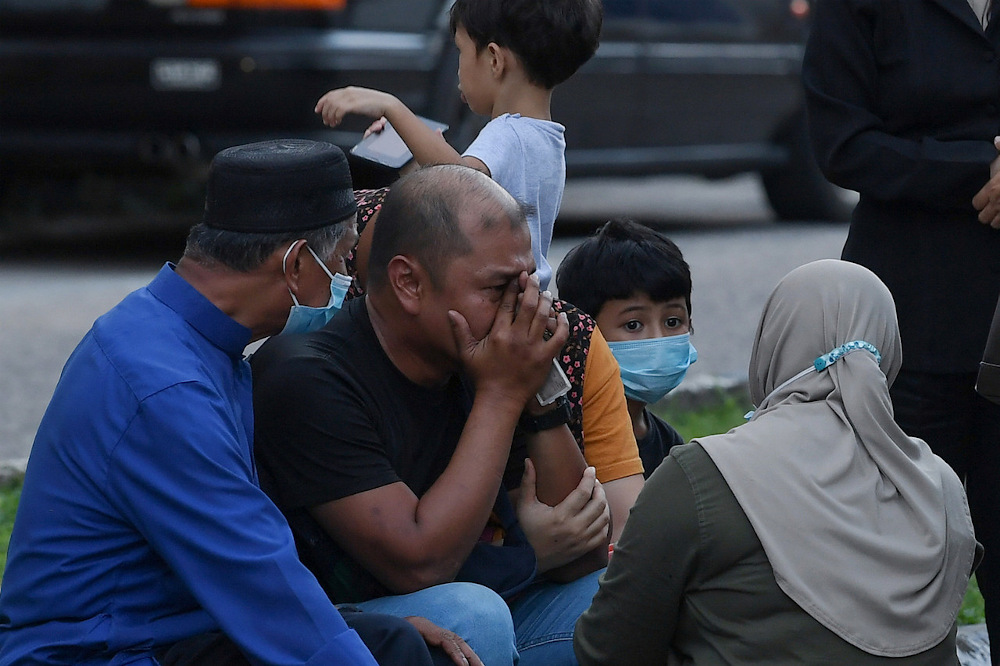 Mohamad Aryan Difa Danish Mohd Azizulu00e2u20acu2122s father Mohd Azizul Mohamad, 35, (2nd left) is seen with family members outside the Sultanah Nur Zahirah Hospital October 25, 2020. u00e2u20acu201d Bernama pic