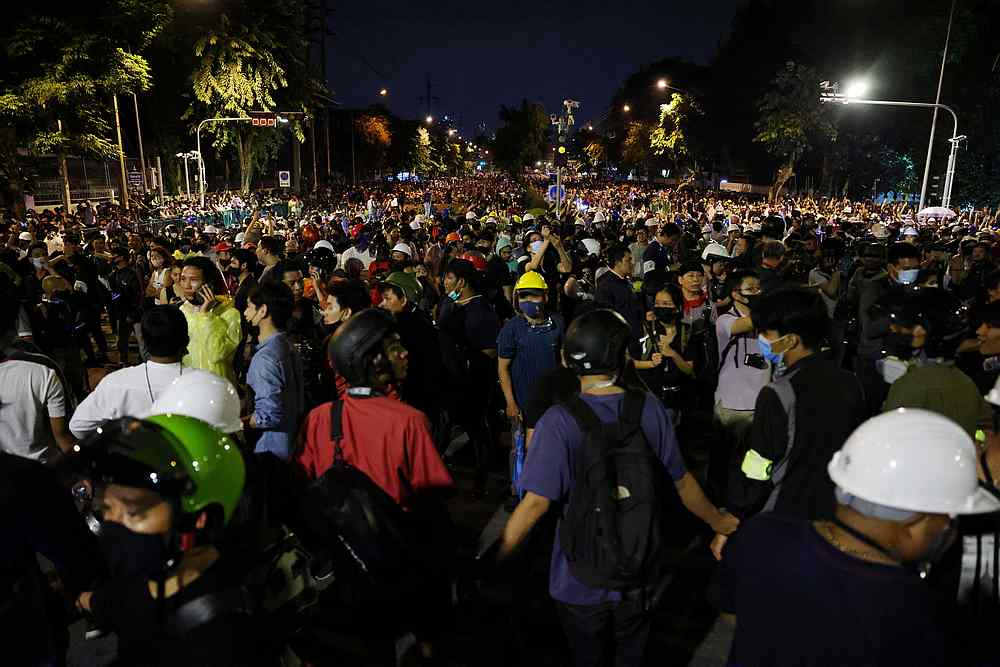 Pro-democracy demonstrators line up as they march near the Government House during an anti-government protest in Bangkok Thailand