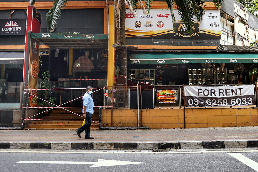 A man walks past a shuttered bar/night club with a ‘For Rent’ sign in Kuala Lumpur during the Covid 19 pandemic. — File picture by Ahmad Zamzahuri