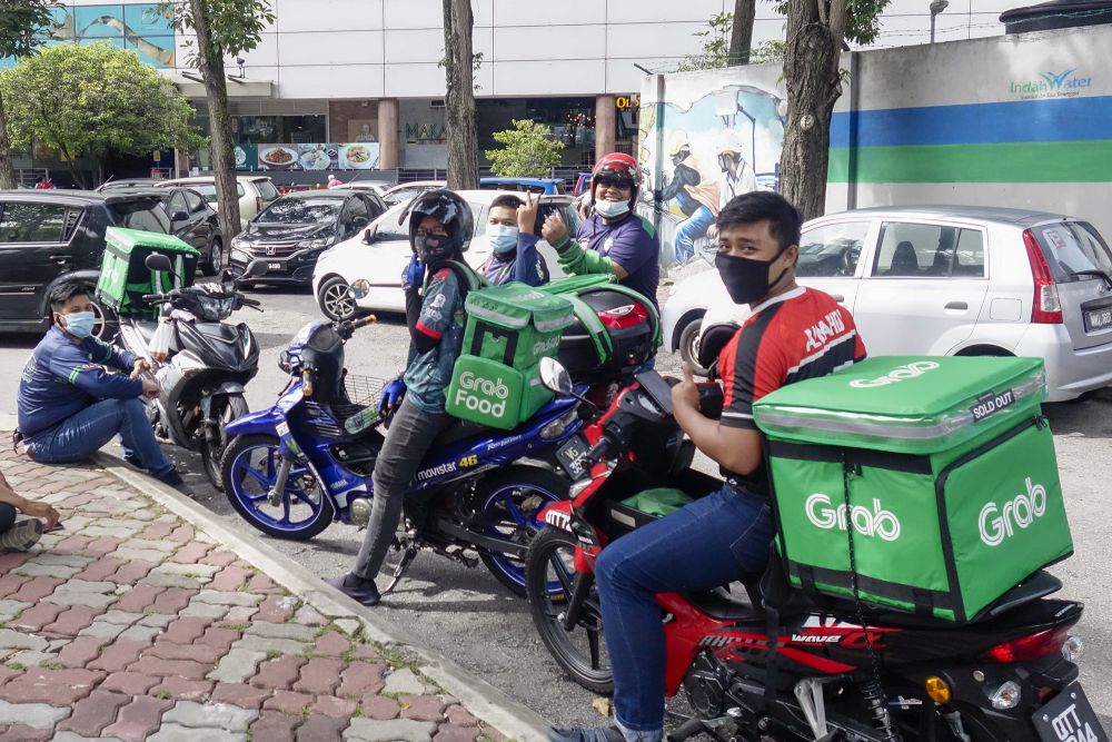GrabFood riders wait to pick up their order at Ampang, Kuala Lumpur October 14, 2020. u00e2u20acu201d Picture by Shafwan Zaidon