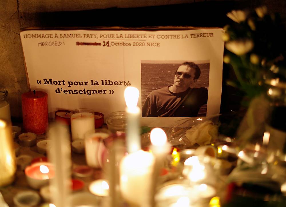 Candles are lit at a makeshift memorial as people gather to pay homage to Samuel Paty, the French teacher who was beheaded on the streets of a Paris suburb, in Nice, France October 21, 2020. u00e2u20acu201d Reuters pic