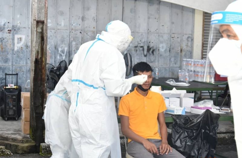 Healthcare staff collect swabs from a villager during the Acting Case Detection operation at Kampung Haji Baki outside Kuching City October 25, 2020. u00e2u20acu201d Picture courtesy of Deputy Chief Ministeru00e2u20acu2122s Officenn