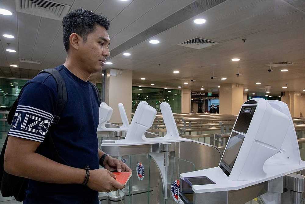 Singapore Immigration and Checkpoints Authority officer Mohammad Shahrin Mohd Ali demonstrating to the media how to use the iris and facial scan at Woodlands checkpoint October 28, 2020. u00e2u20acu201d TODAY pic