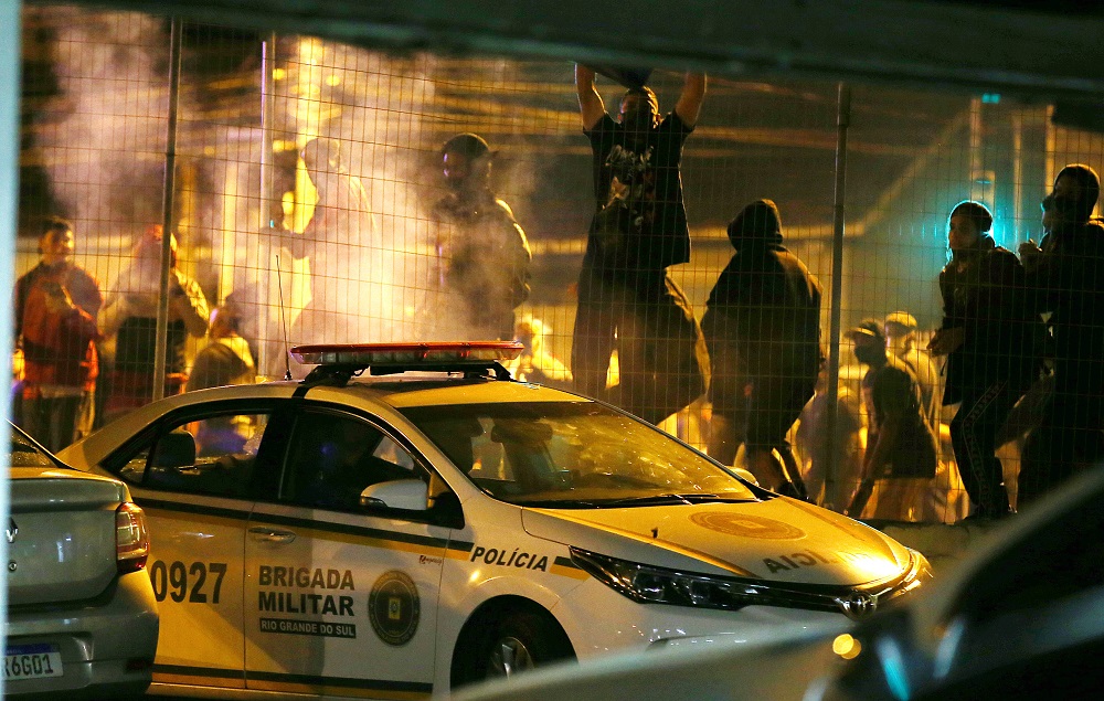 Demonstrators vandalise a police vehicle during a protest against racism in Porto Alegre November 20, 2020. — Reuters pic