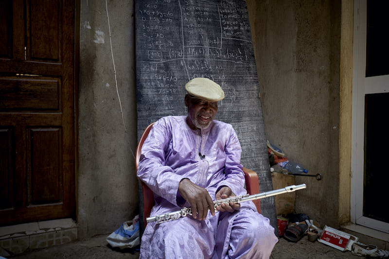 Malian musician Sory Bamba, 82, holds a flute in his courtyard in Mopti, central Mali May 26, 2020. u00e2u20acu201d AFP pic