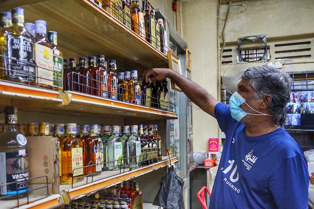 S. Rajan shows the liquor sold at his convenience shop in Kuala Lumpur November 19, 2020. — Picture by Ahmad Zamzahuri