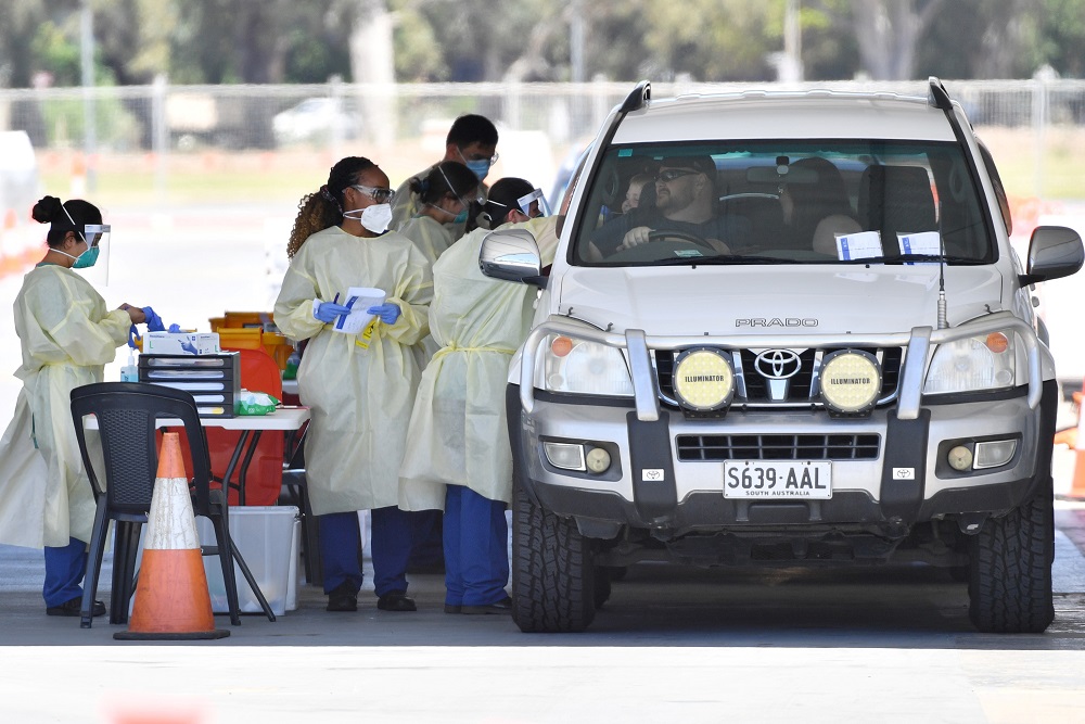 Health workers test the South Australia public at a drive-through coronavirus disease testing site in Adelaide November 19, 2020. u00e2u20acu201dAAP Image/David Mariuz via Reuters