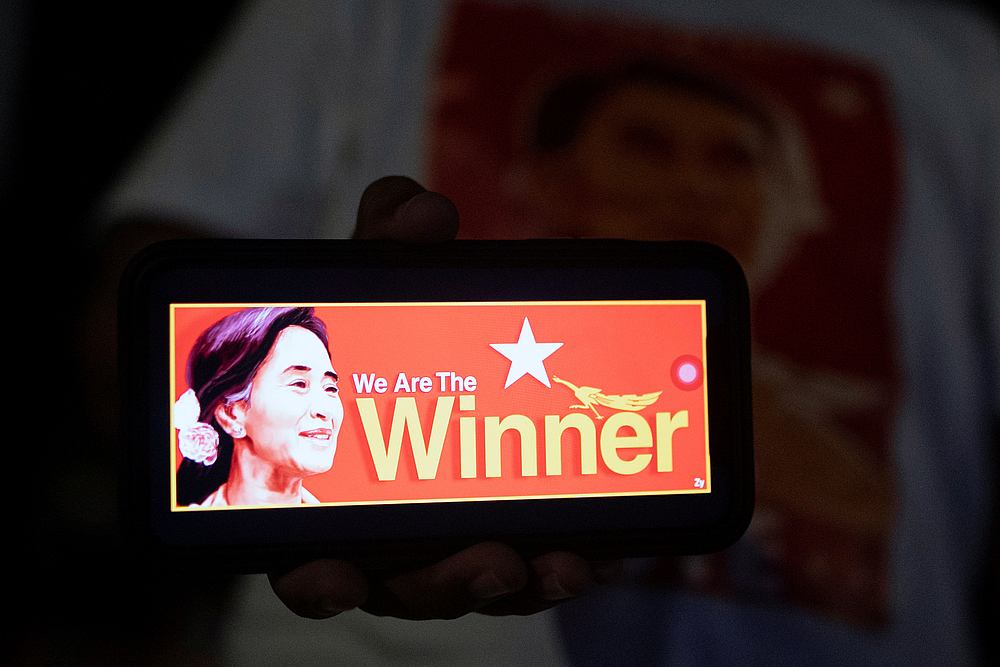 Picture of Myanmar State Counselor Aung San Suu Kyi is shown on a mobile phone as supporters of the National League for Democracy (NLD) party wait for election results in Yangon, Myanmar November 8, 2020. u00e2u20acu201d Reuters pic