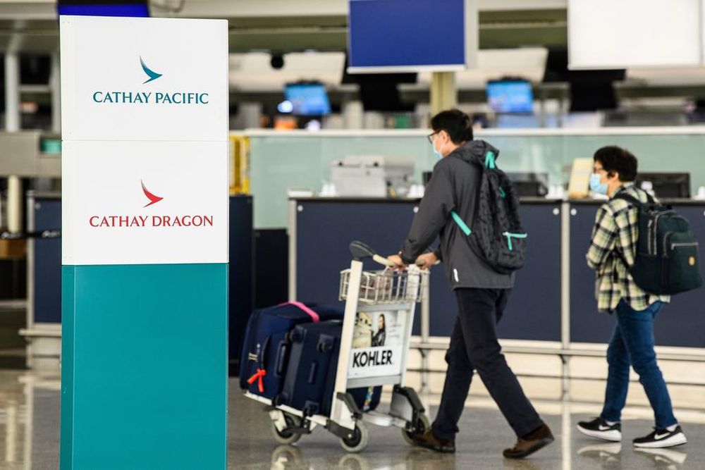 Passengers walking near Cathay Pacific check-in counters at Hong Kong International Airport on Oct 20, 2020. u00e2u20acu201d AFP pic