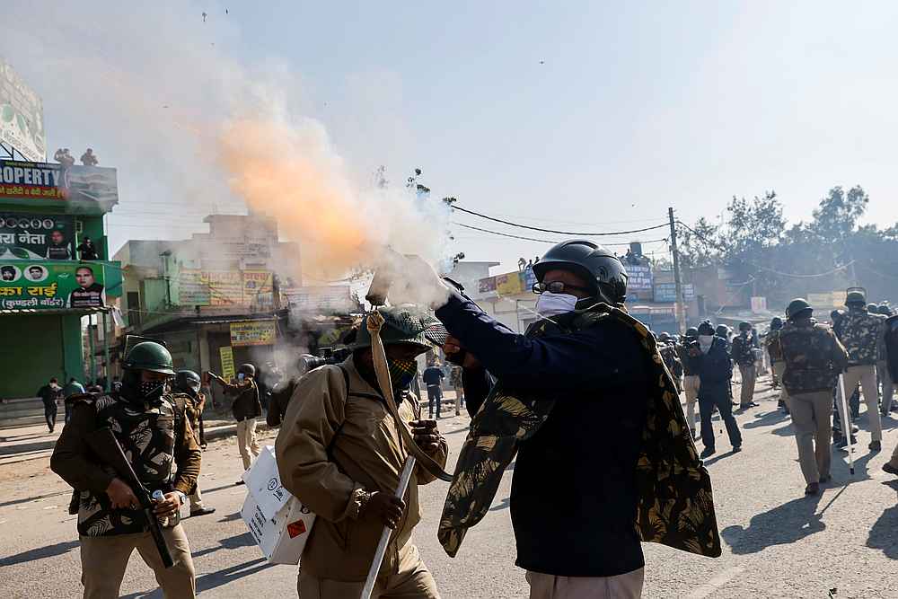 A police officer fires tear gas to stop farmers opposing the newly passed farm bills from entering the national capital Delhi, at Singhu border, India November 27, 2020. u00e2u20acu201d Reuters pic