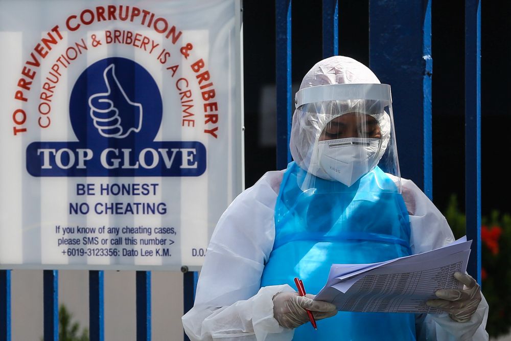 A health worker in protective suit is pictured outside Top Gloveu00e2u20acu2122s female staff dormitory in Klang November 18, 2020. u00e2u20acu201d Picture by Yusof Mat Isann