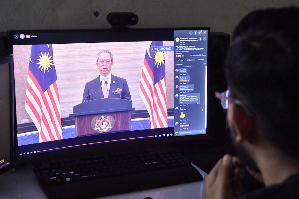 A viewer watches as Prime Minister Tan Sri Muhyiddin Yassin launches the National Tourism Policy 2020-2030 online. u00e2u20acu201d Bernama pic