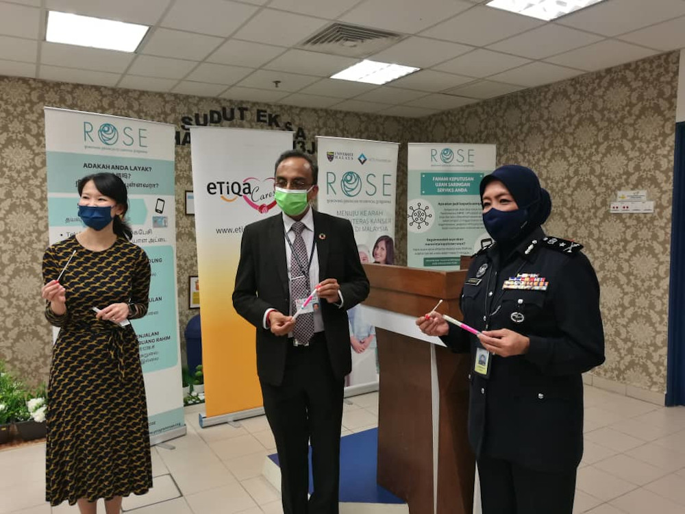 Bukit Aman Corporate Communications head Datuk Asmawati Ahmad (right) showing the HPV test kit during the Frontliner Uniting Against Cervical Cancer Programme for police personnel at the Johor police contingent headquarters in Johor Baru December 21, 2020. — Picture by Ben Tan
