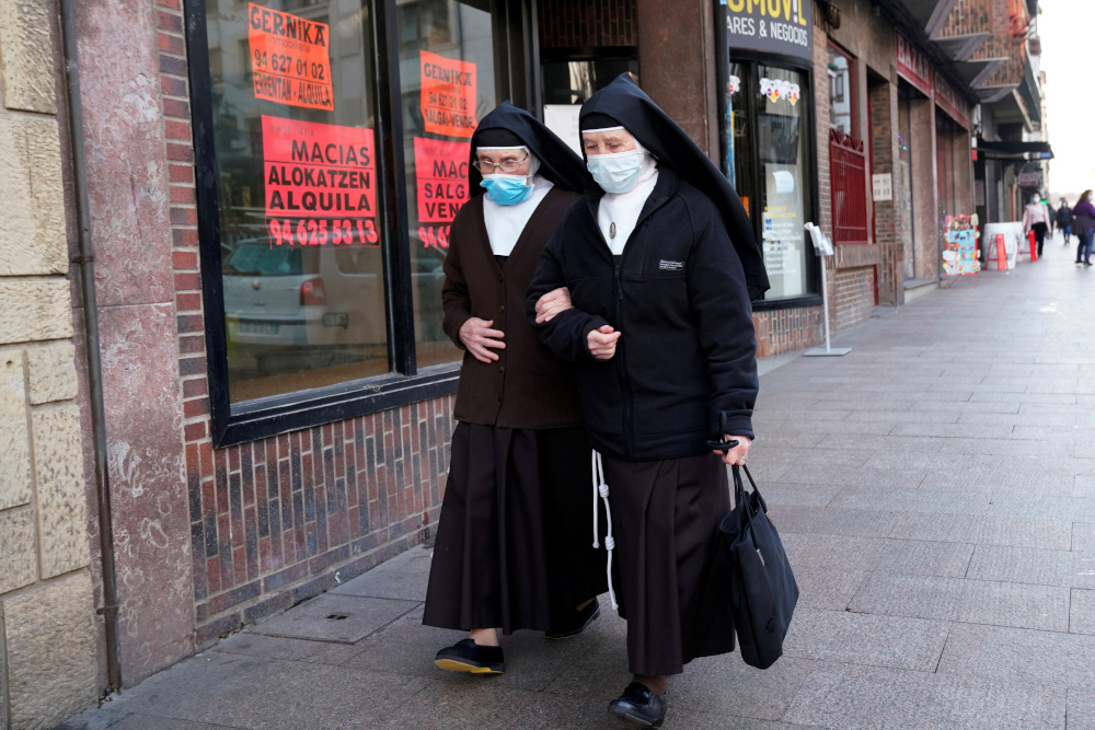 Nuns wearing protective masks walk through the Basque town of Guernica, Spain, during the coronavirus disease outbreak, December 17, 2020. u00e2u20acu201d Reuters picnn