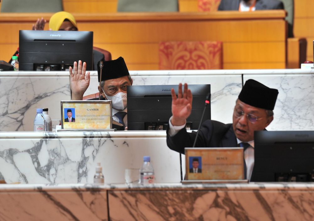 Prime Minister Tan Sri Muhyiddin Yassin and Johor Menteri Besar Datuk Ir Hasni Mohammad raising their hands in agreement with the passing of the Johor State Budget 2021 in the State Legislative Assembly, Kota Iskandar, December 6, 2020. u00e2u20acu201d Bernama pic