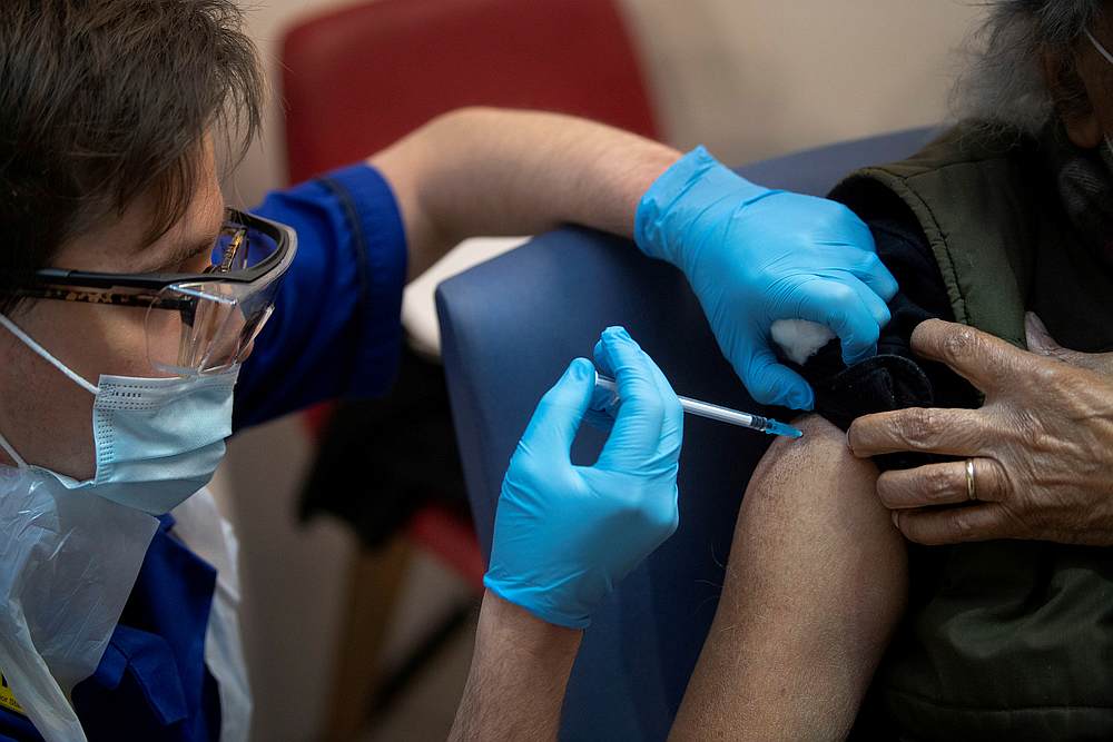 A man receives the first of two Pfizer/BioNTech Covid-19 vaccine jabs, at Guy's Hospital, in London, Britain December 8, 2020. — Pool pic via Reuters