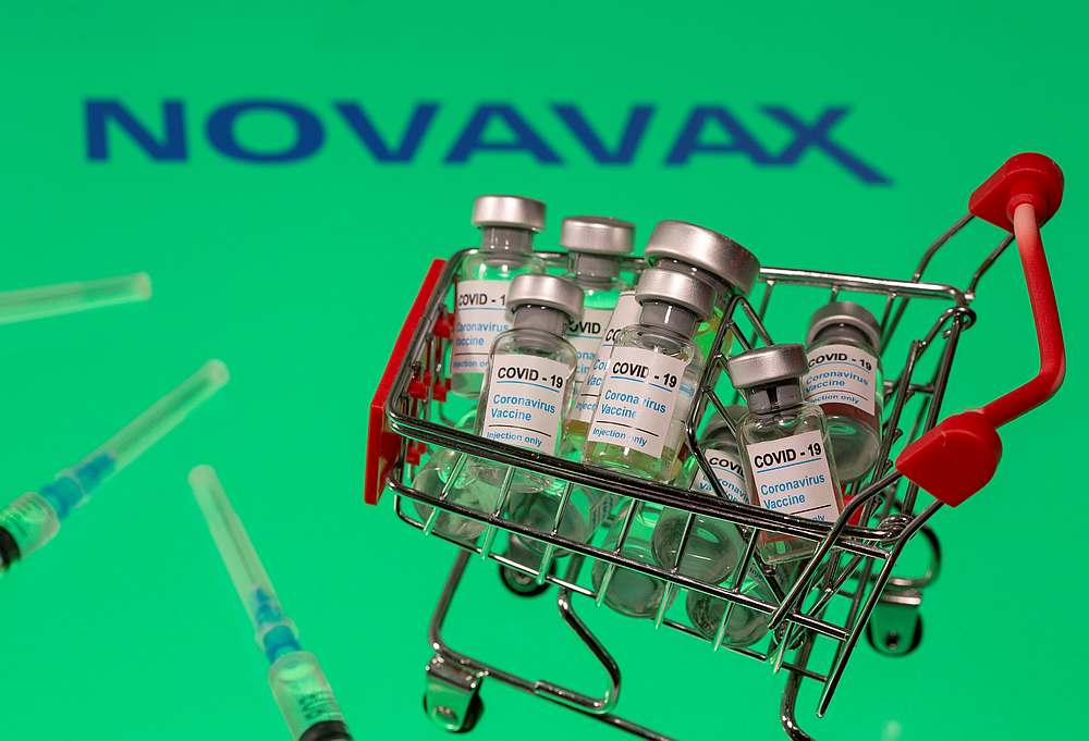 A small shopping basket filled with vials labelled 'Covid-19 u00e2u20acu201d Coronavirus Vaccine' and medical sryinges are placed on a Novavax logo in this illustration taken November 29, 2020. u00e2u20acu201d Reuters pic