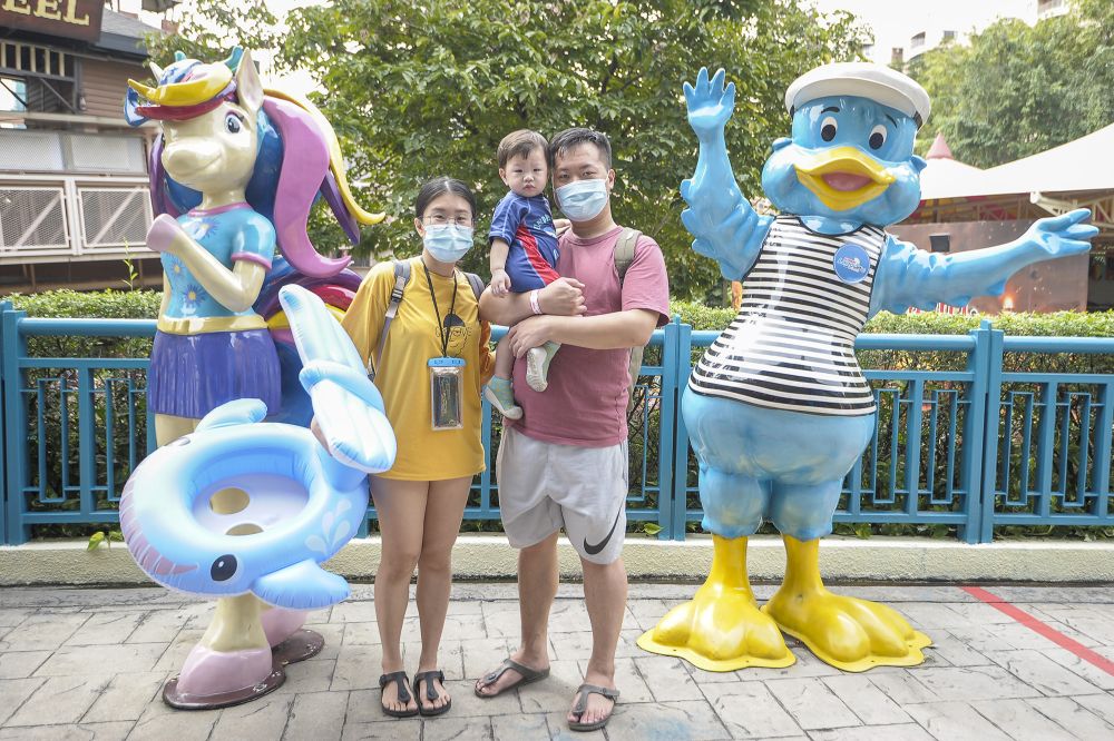Sunway Berhad executive Ng Poh Li is pictured with husband Au Wei Jing and their child at Sunway Lagoon, Subang Jaya December 19, 2020. — Picture by Shafwan Zaidon